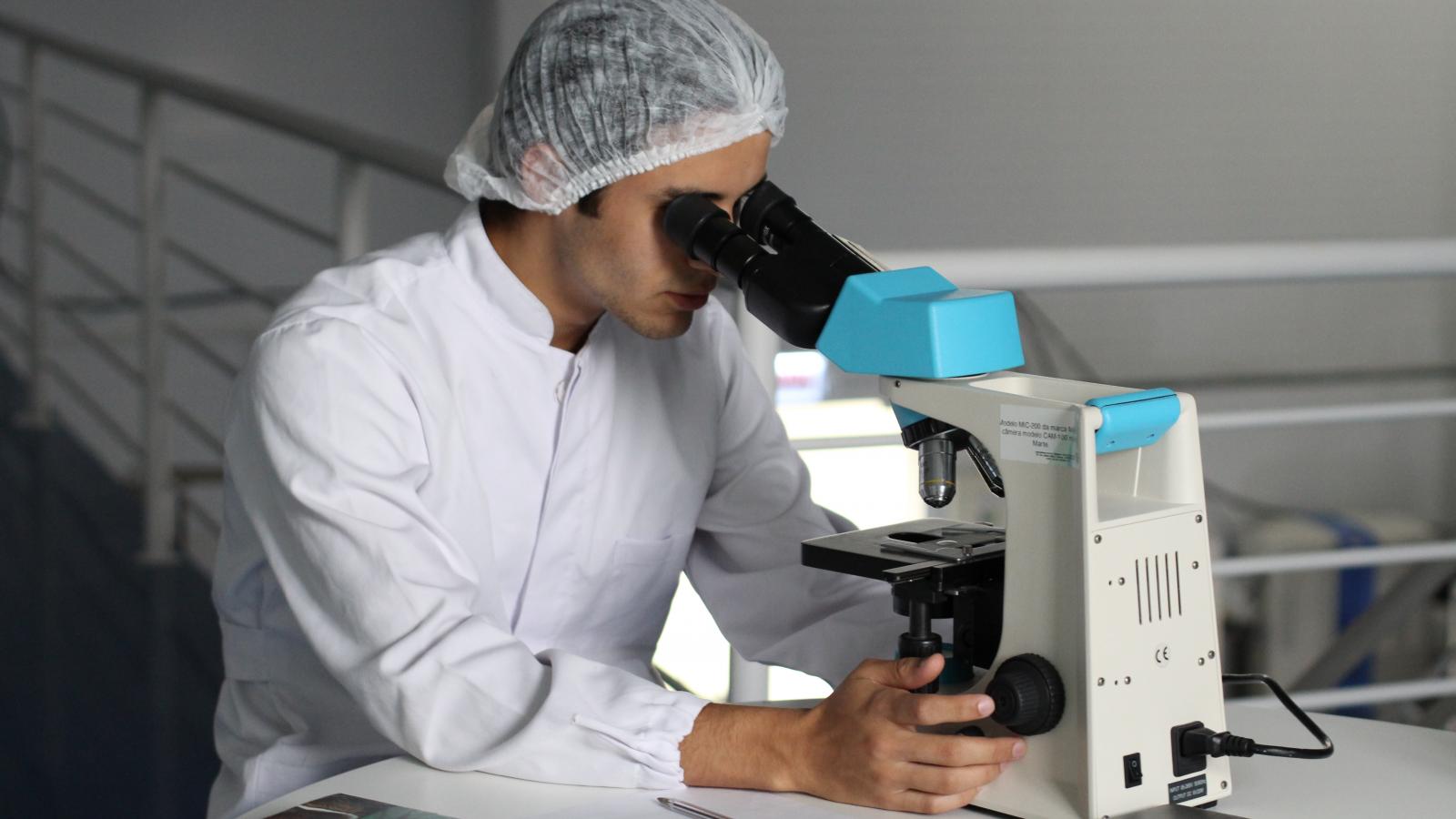 Male scientist looking in a microscope