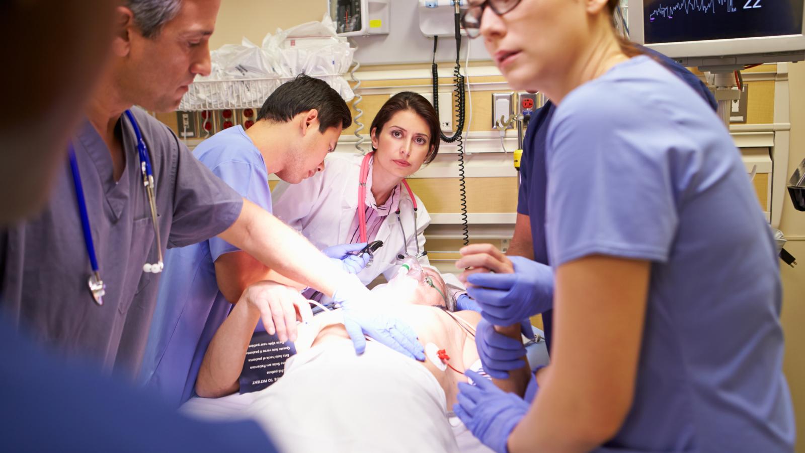 Doctors working on a patient in A&E