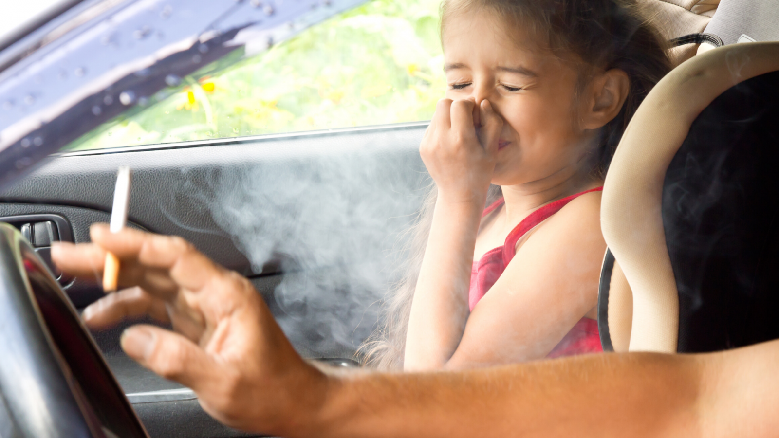 adult smoking around child in car