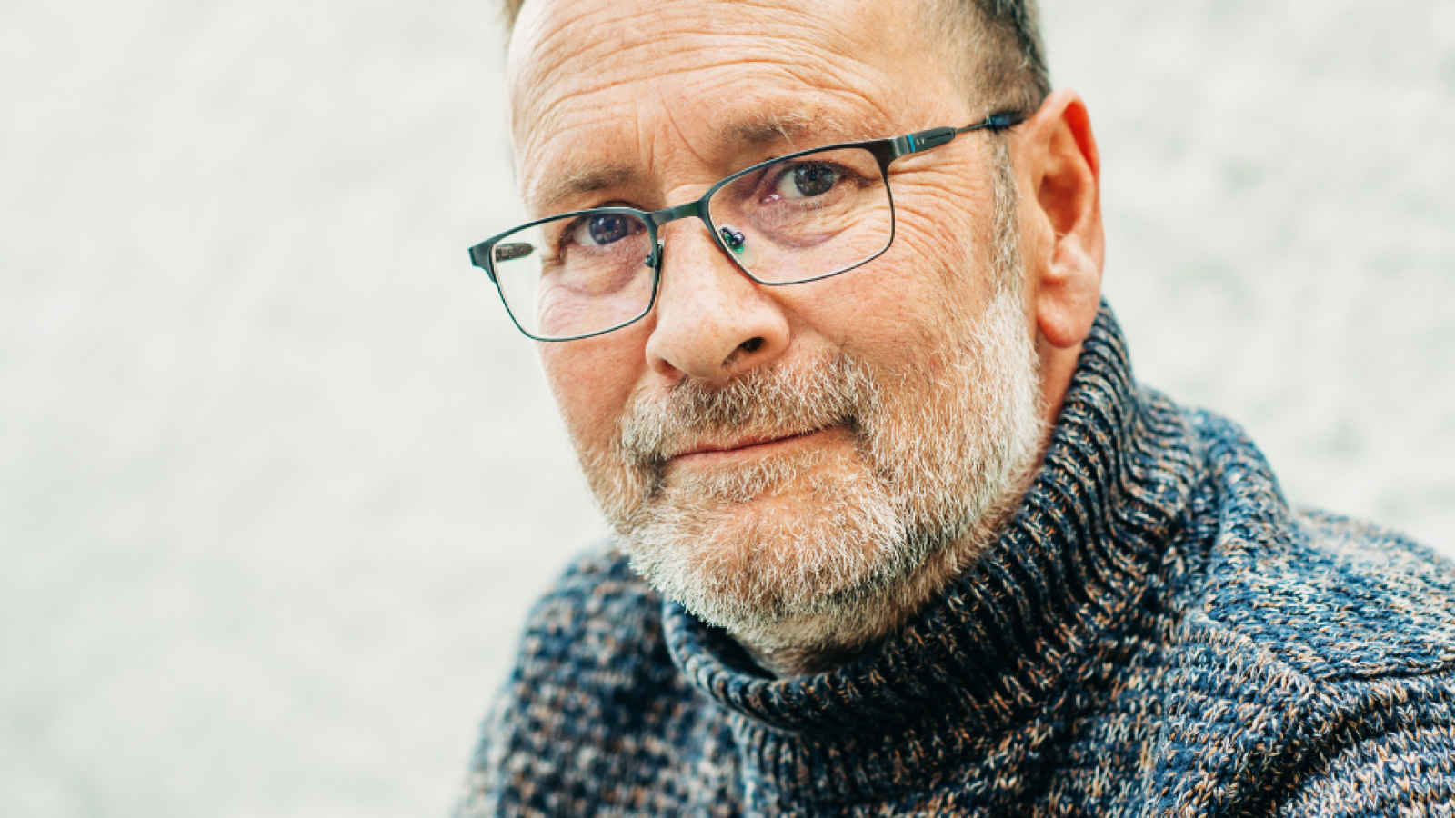 middle-aged white man with glasses and wooly jumper