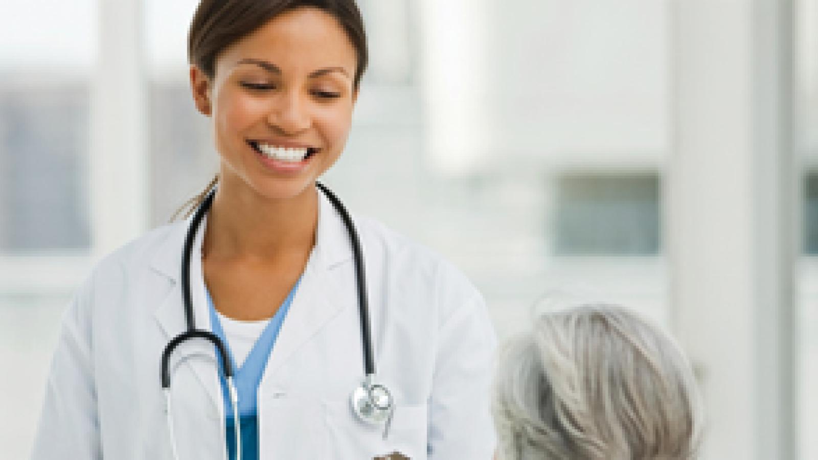 Young female doctor talking to a female patient