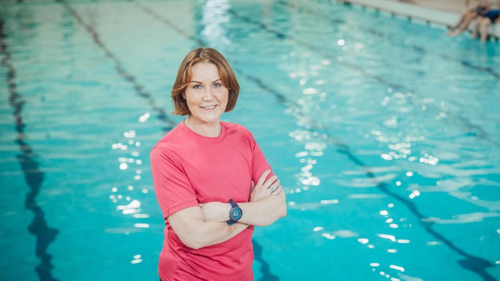 Breast cancer survivor Orla Brennan infront of a swimming pool