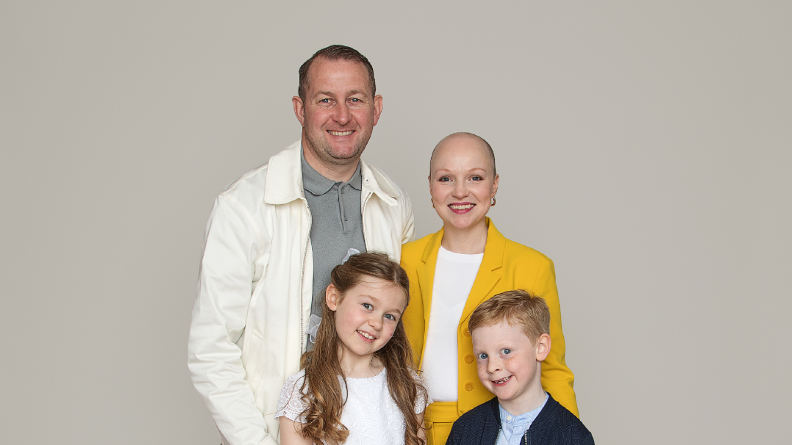 Emma Aspell, breast cancer patient, with family on her daughter's communion