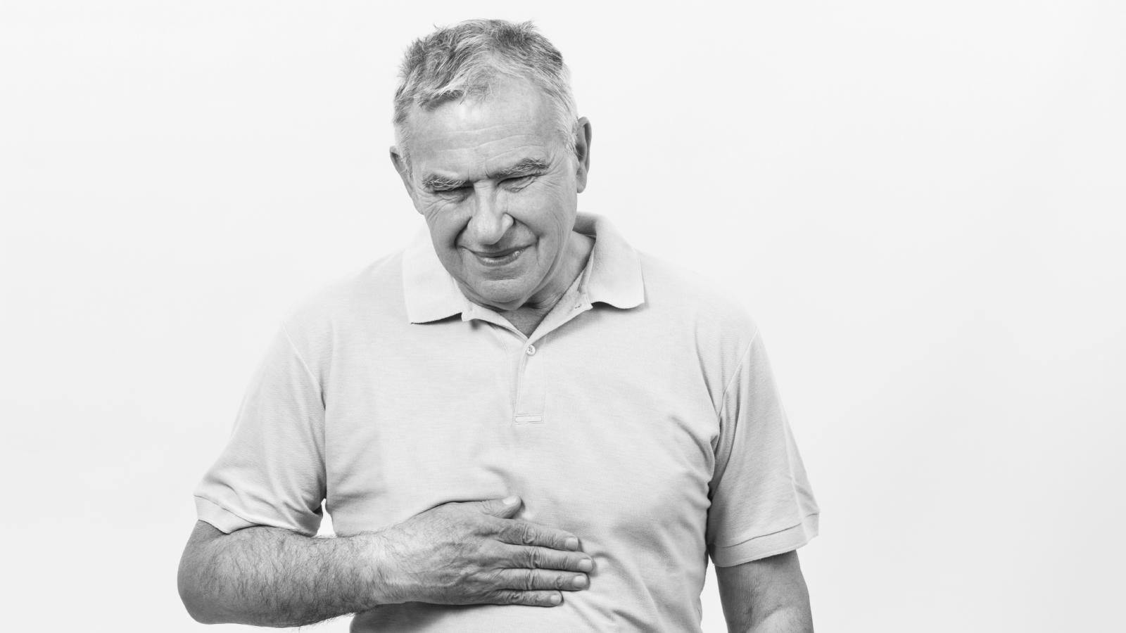 Older man touching his stomach