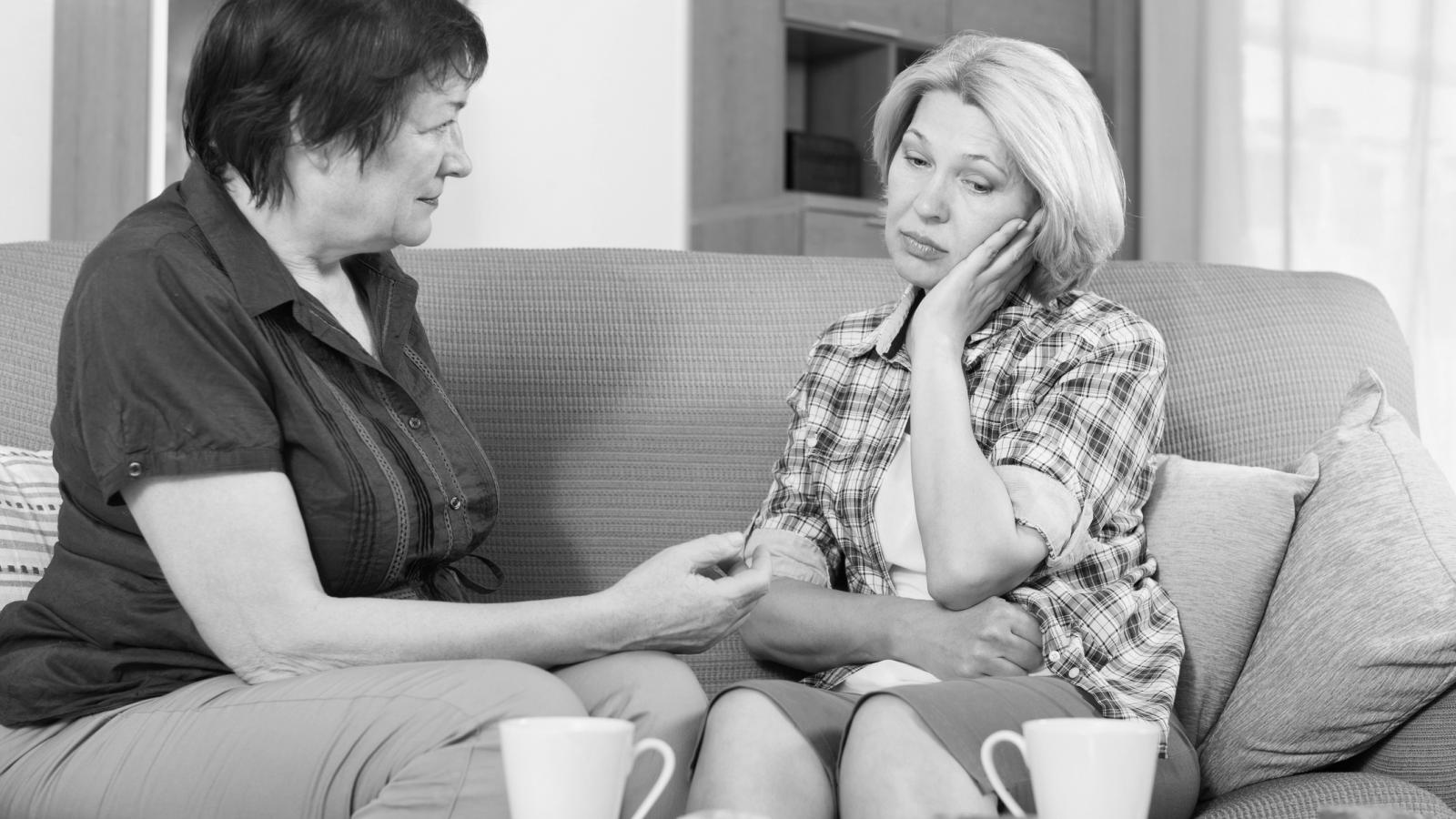 Two mothers talking over tea