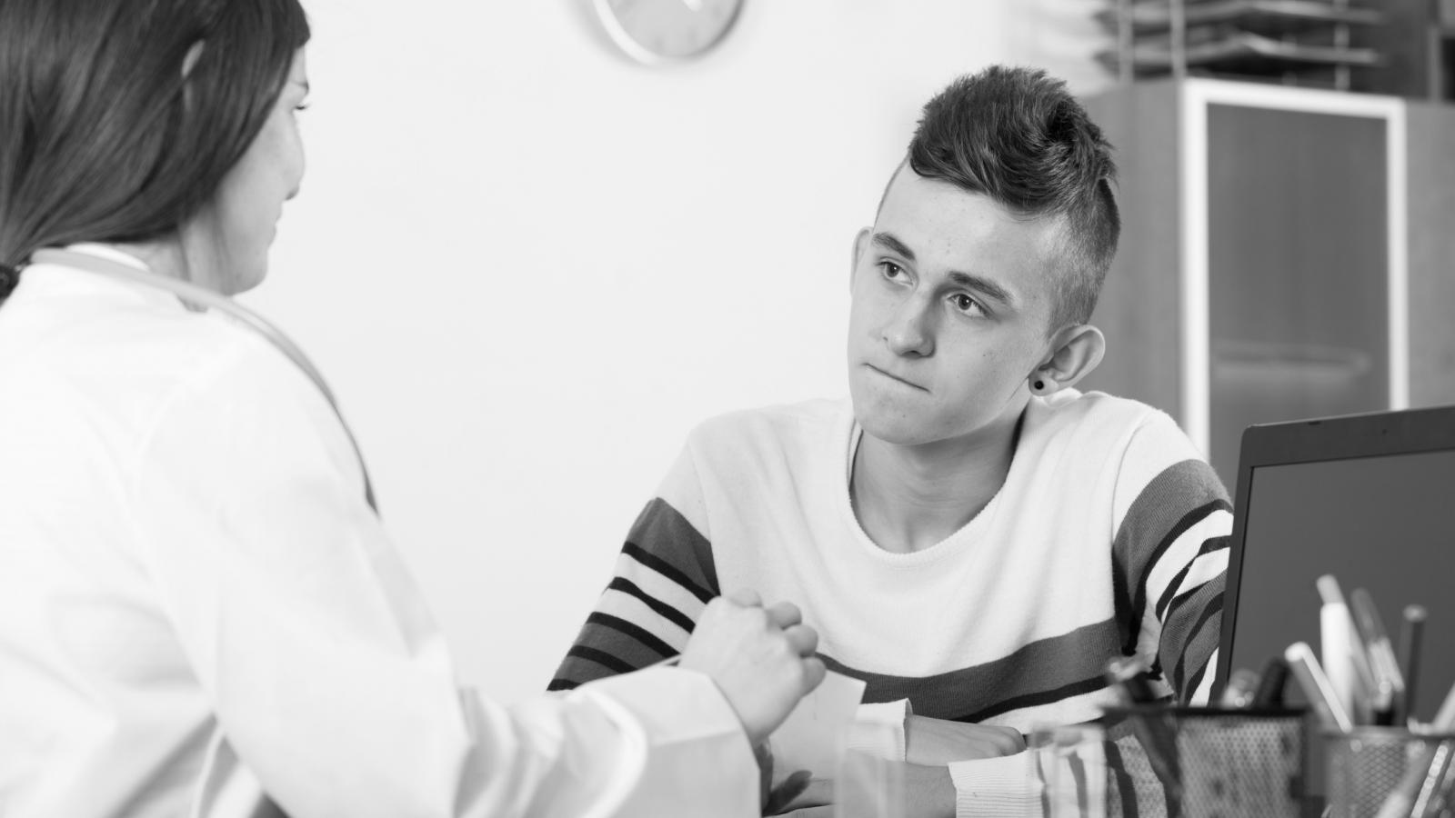 Teenage boy talking to a doctor