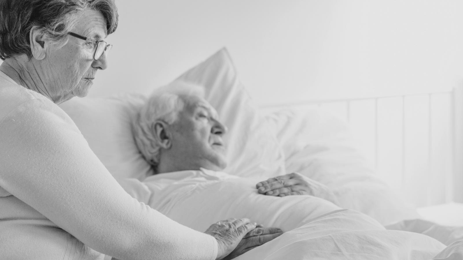 Wife caring for her husband in bed