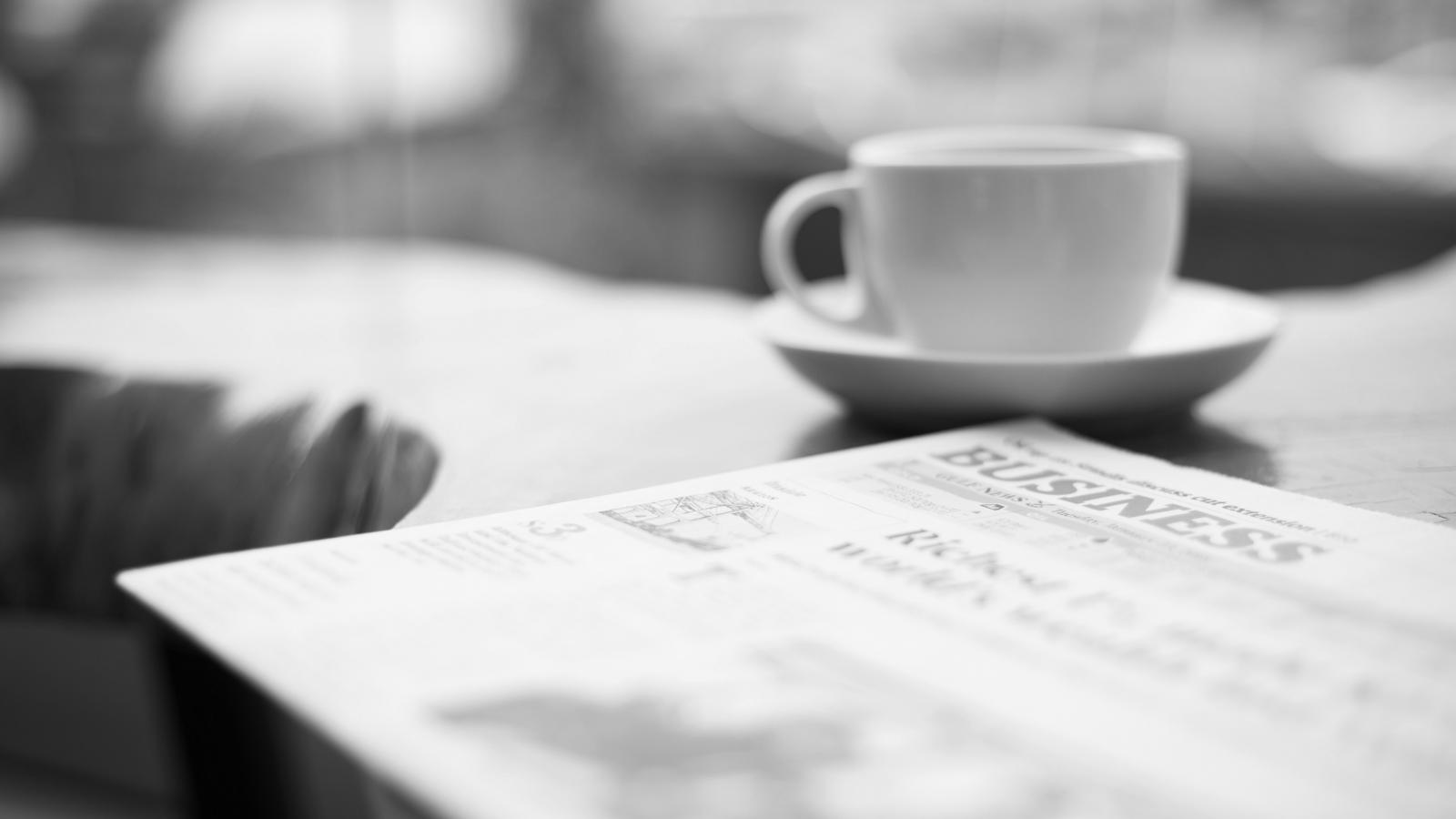 Newspaper and coffee cup