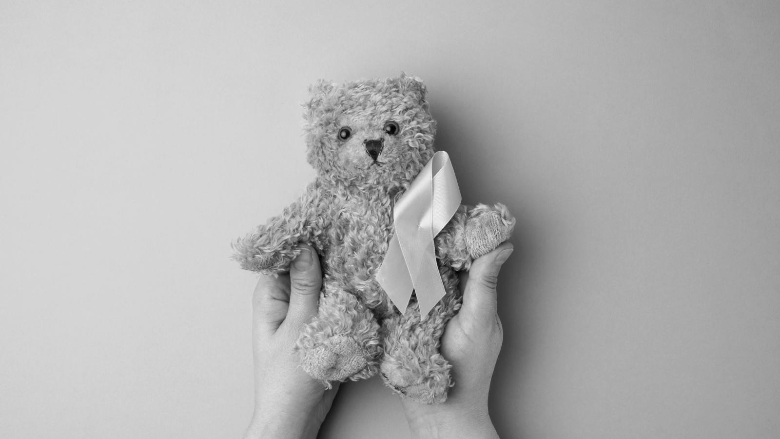 A teddy wearing the gold ribbon that symbolises children's cancer
