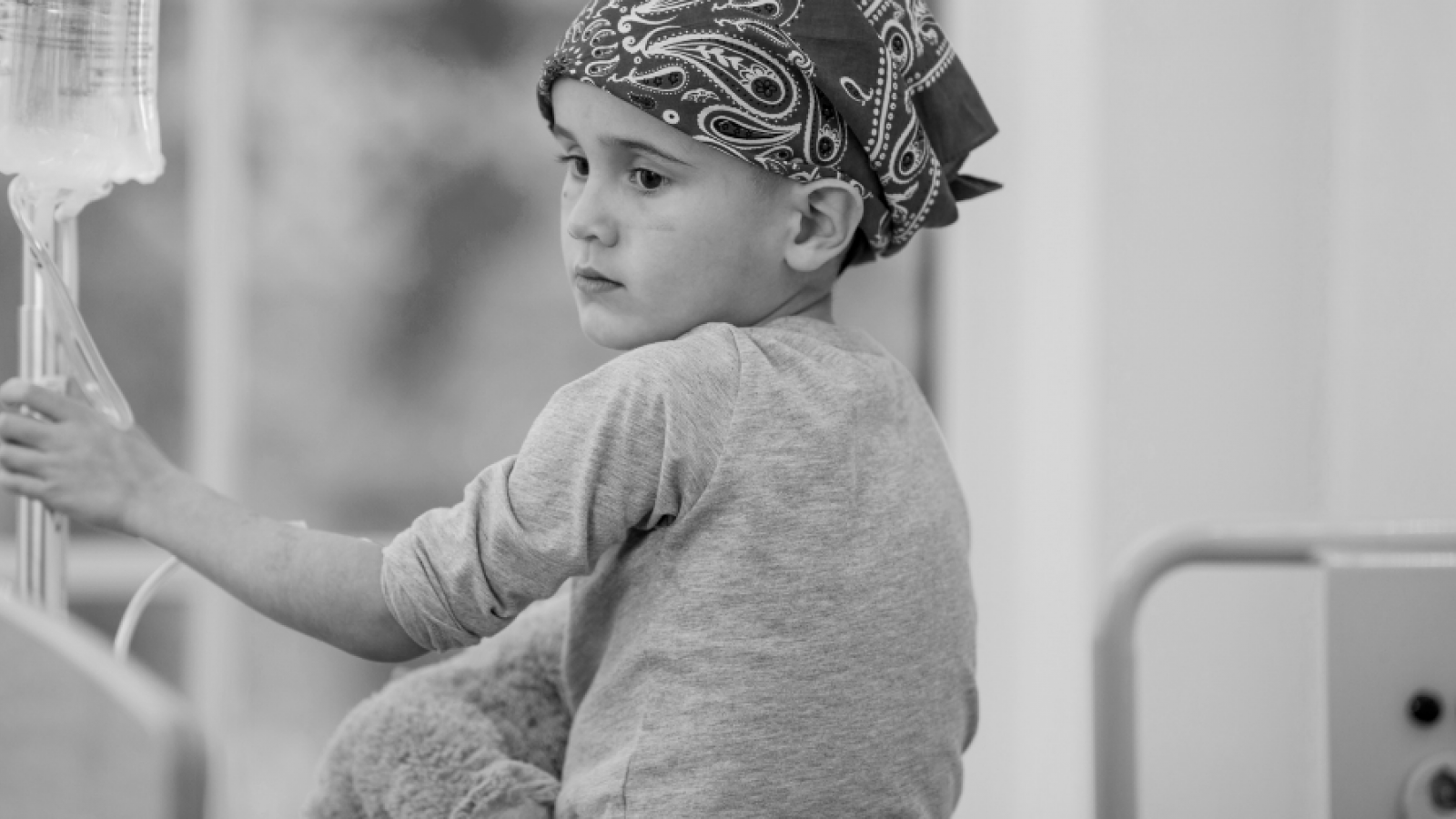 Boy with hair loss in hospital wearing a bandana